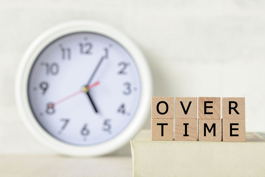 image showing a clock and building blocks spelling overtime