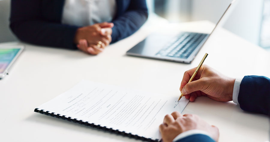 Lawyer taking notes for a wrongful termination case.